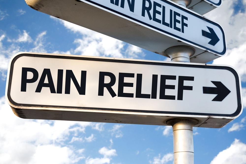 Pain Relief direction sign on sky background 1